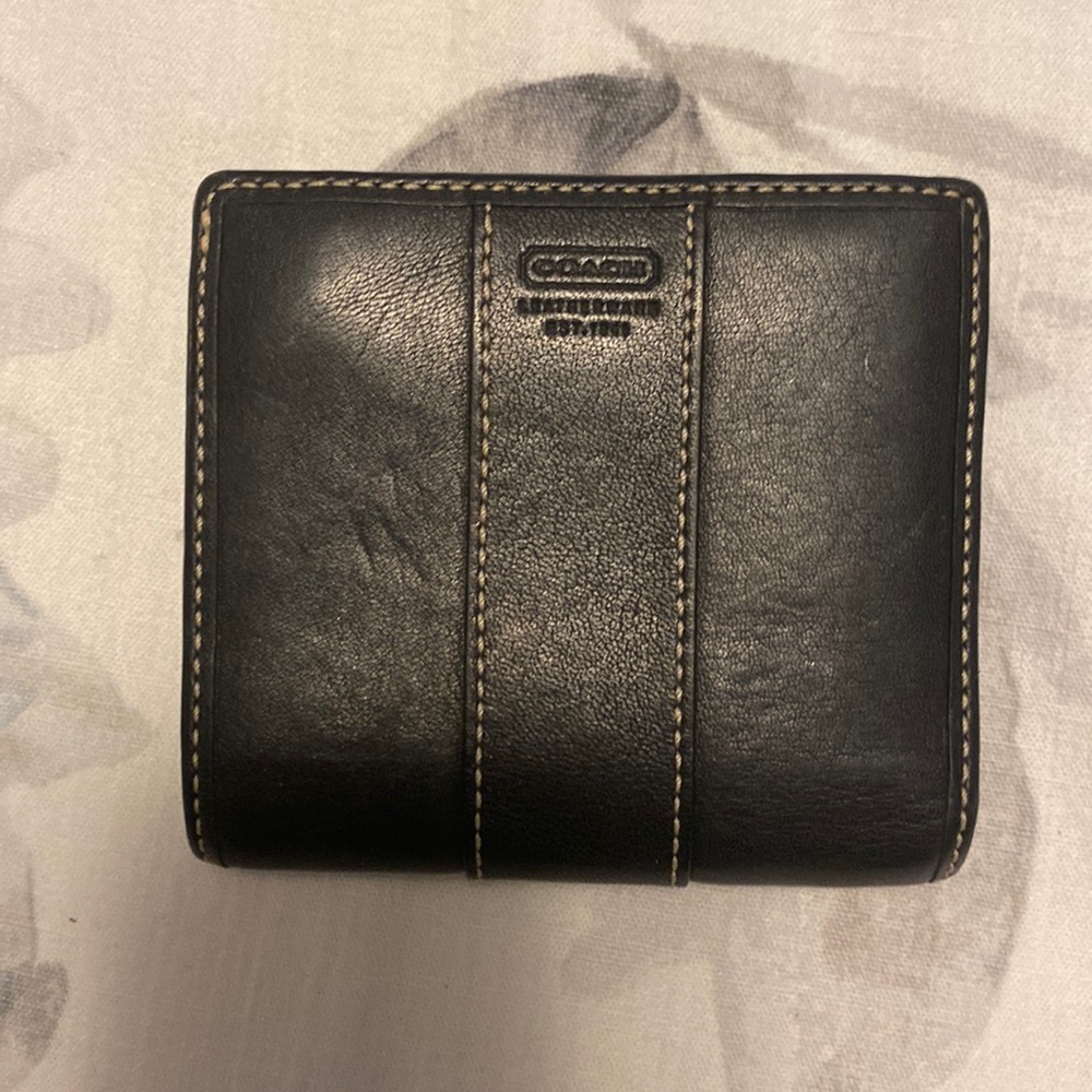 Used, good condition black Coach wallet with silver clasp.